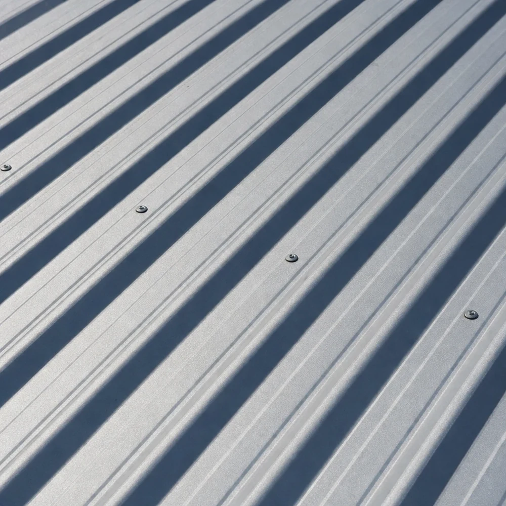 Close-up of light-grey Colorbond roof sheets with crisp diagonal ribs
