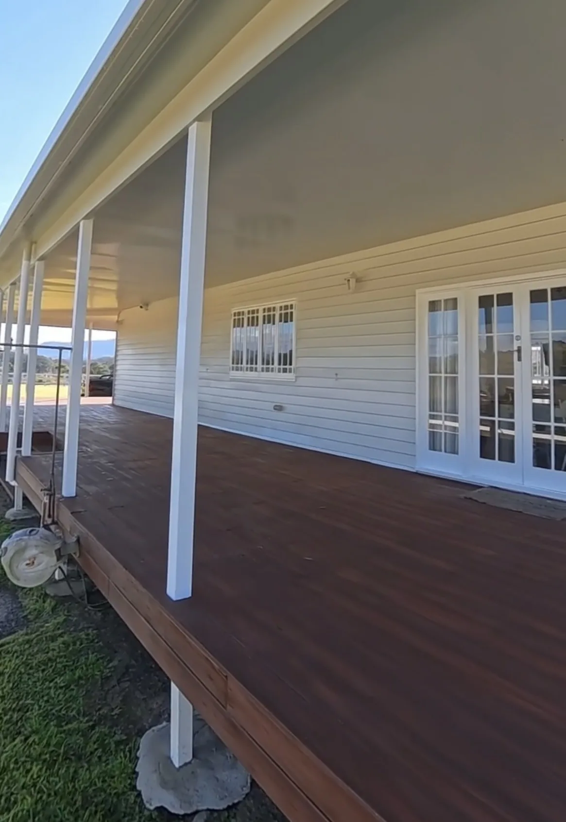 Freshly painted white weatherboard home with a timber verandah