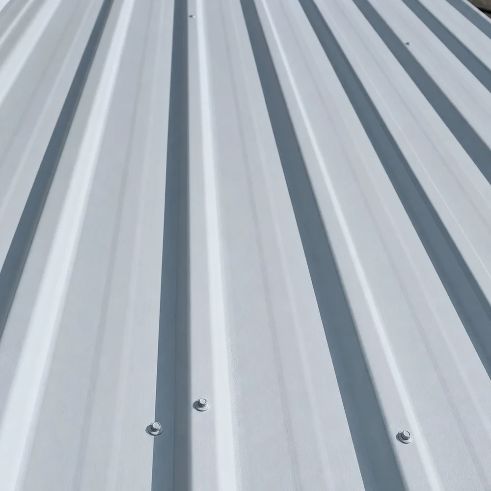 Close-up of bright silver-grey Colorbond roof sheets with strong parallel ribs